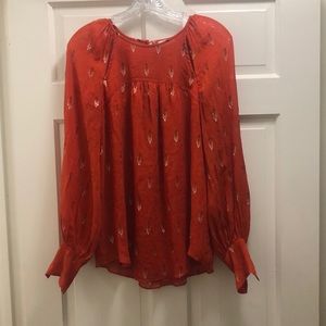 Joie. Red blouse with sparkle detail. Subtle cutouts at neckline.